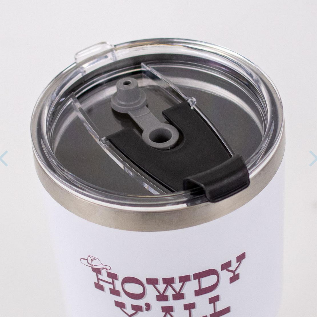 The Howdy Y'all Tumbler from the Gameday Collection features a stainless steel white design with a clear plastic lid and black sliding mouthpiece. The front showcases "HOWDY Y'ALL" in maroon with a small cowboy hat illustration above the letter "H." Available sizes: 12 oz, 20 oz, and 30 oz.