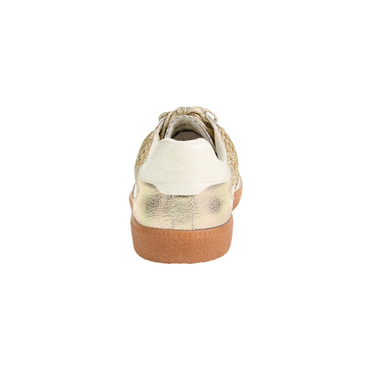The Tropics Sneaker - Metallic Gold features woven details, a textured metallic finish, a white heel accent, and a light brown rubber sole. Available sizes range from 5 to 12.