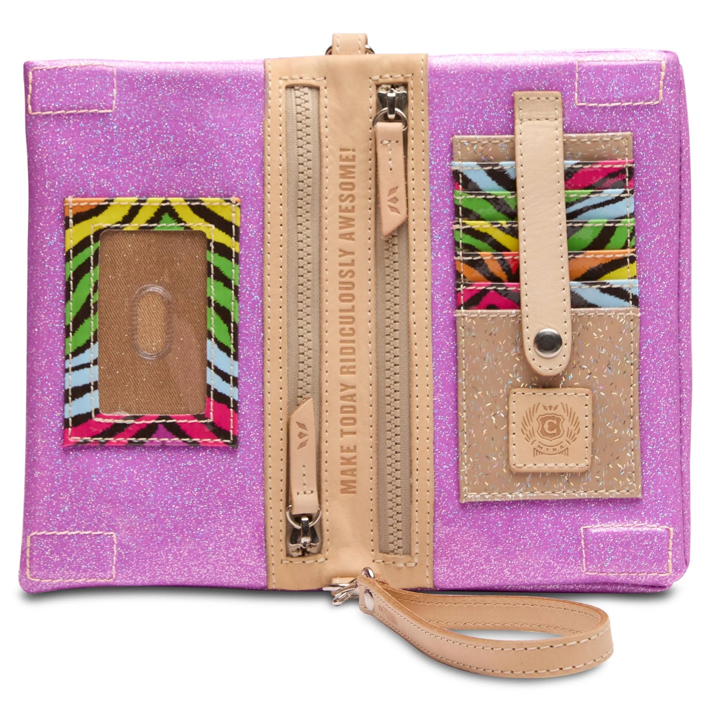 The Uptown Crossbody, Twy is a glittery pink wallet with beige trim. Features zipper compartments, clear ID slot, colorful zebra-striped card slots, wristlet strap, and inner lining with "MAKE TODAY RIDICULOUSLY AWESOME!" Available in one size: 8” L x 5” H x 1.25” D.