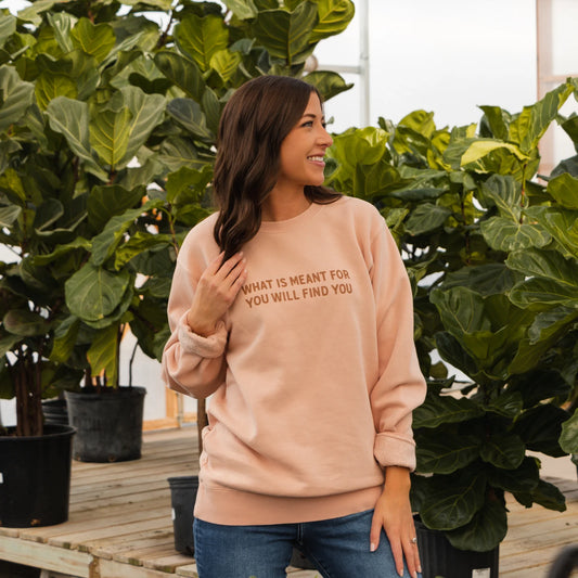 Blush "What is Meant for You Crewneck" with "WHAT IS MEANT FOR YOU WILL FIND YOU" text; available in sizes XS–XXL.