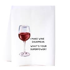 Tea towel by Cora and Pate says I make one disappear what’s your superpower and it has a glass of red wine