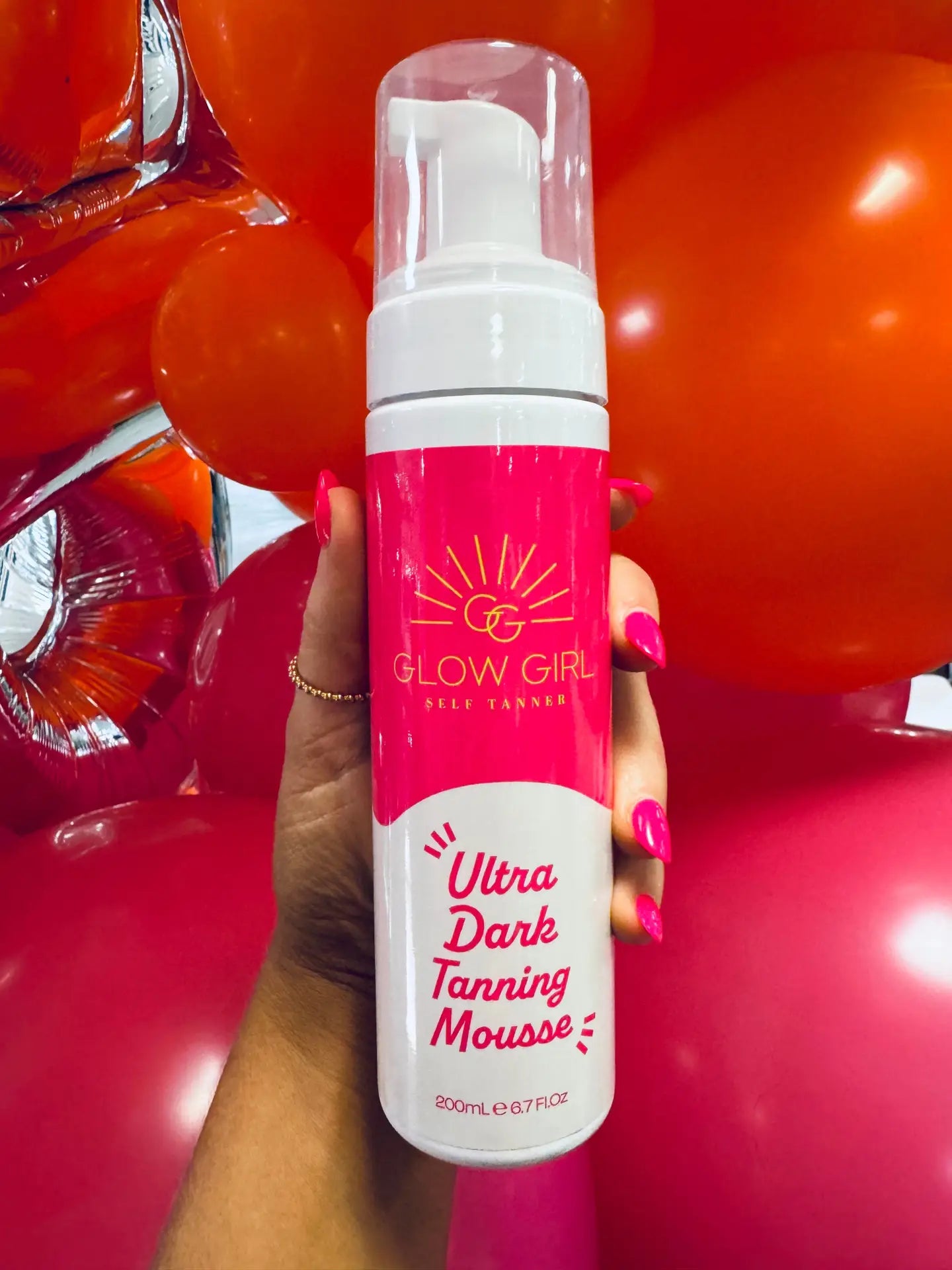Glow Girl Ultra Dark Tanning Mousse: Pink and white bottle with pump, instant bronzing. Sizes available: 125ml, 200ml.