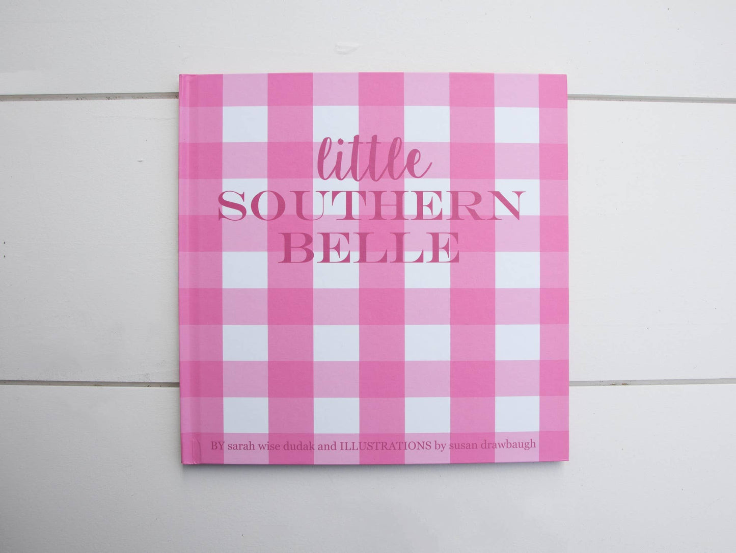 Little Southern Belle" children's book, pink and white checkered cover. Available in hardcover and paperback sizes.