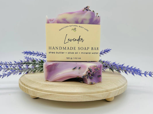 The Saratoga natural body care is lavender. It’s a handmade soap bar with Shea butter olive oil mineral water it’s 4.2 ounces it’s moisturizing, nourishing and gentle. It is cream with purple with some lavender seeds.