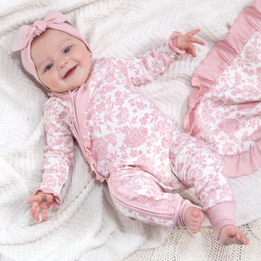 Pink embroidery zippered romper with long sleeves; available in sizes newborn to 24 months.