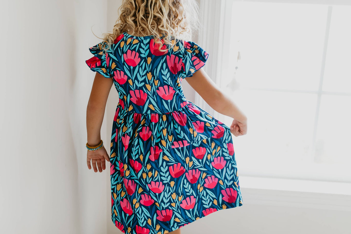 Kids Blue Floral Flutter Sleeve Dress with bold pink and green prints, available in sizes 2T-6.