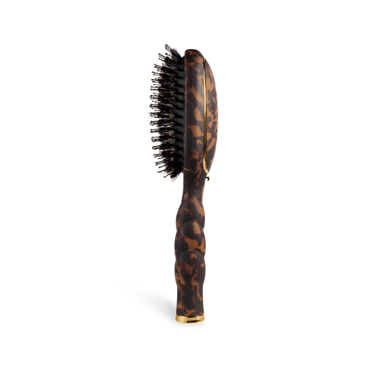 The Boar Bristle Hair Brush | Tortoise has a tortoiseshell handle, black boar bristles. Available in regular and travel sizes.