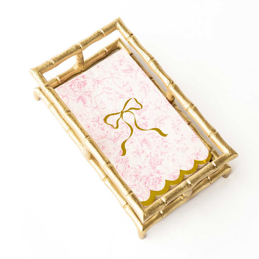 Pink Bow Toile Paper Guest Towel with pink floral pattern, gold scalloped edge, gold bow. Available in standard guest size.
