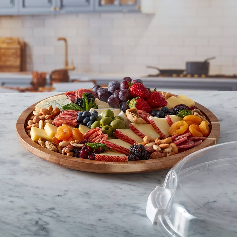 FW 14 ROUND MAKE AND TAKE- ACACIA 1 WHIT cutting board with plastic lid, available in multiple sizes.