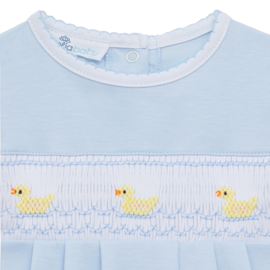 Light blue bubble with chest smocking, hand-embroidered ducklings, and “pixbaby” tag inside collar. Available in multiple sizes.