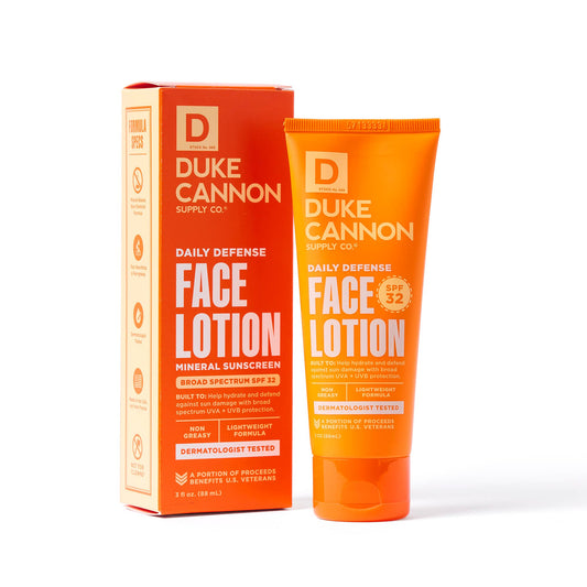 Orange tube of Daily Defense Face Lotion, mineral sunscreen SPF 32, dermatologist tested. Sizes: 2oz, 3.4oz. Supports veterans.