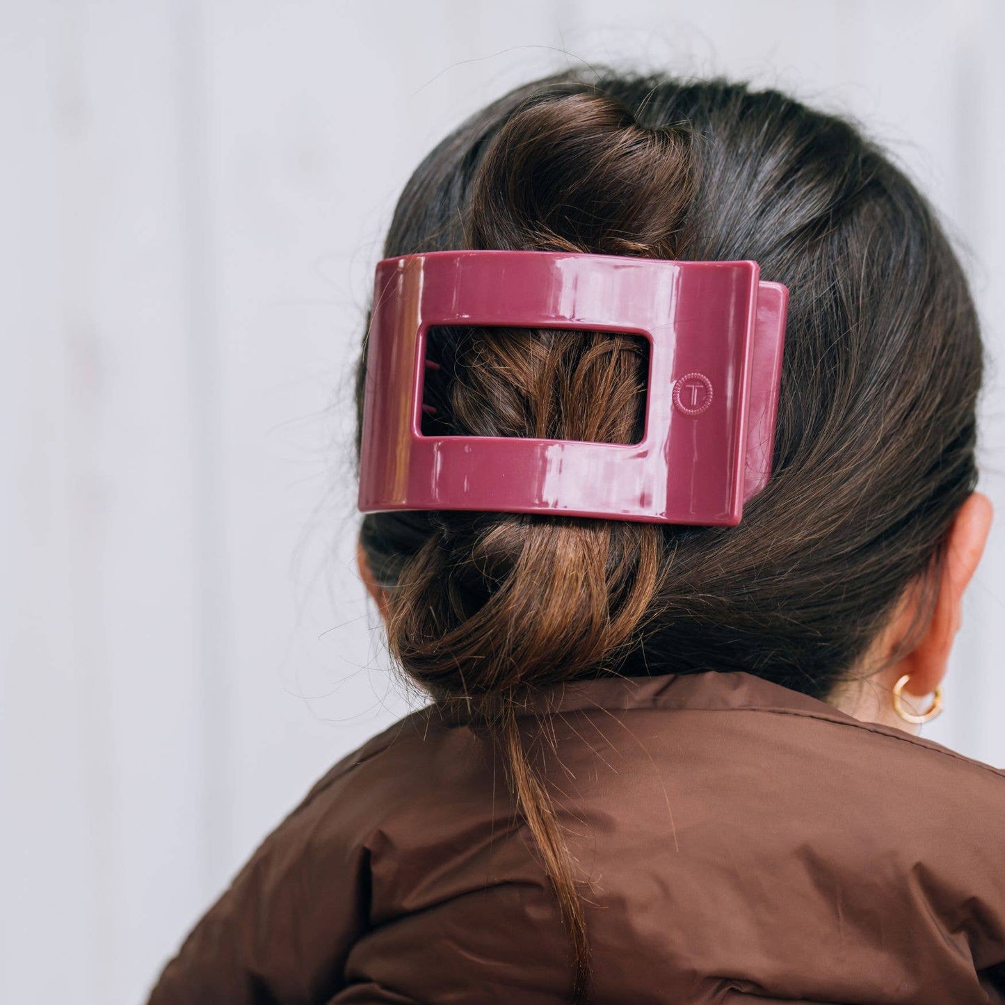 Large, glossy maroon TELETIES Flat Rectangle Hair Clip shown in use; available in small, medium, and large sizes.