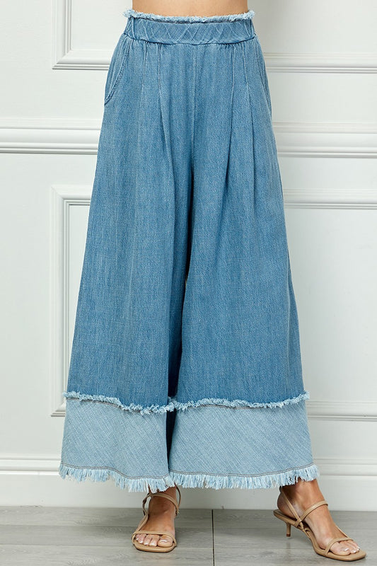 Fringe Detail Wide Denim Pants with wide legs, frayed hems, layered panels; available in sizes XS-XL.