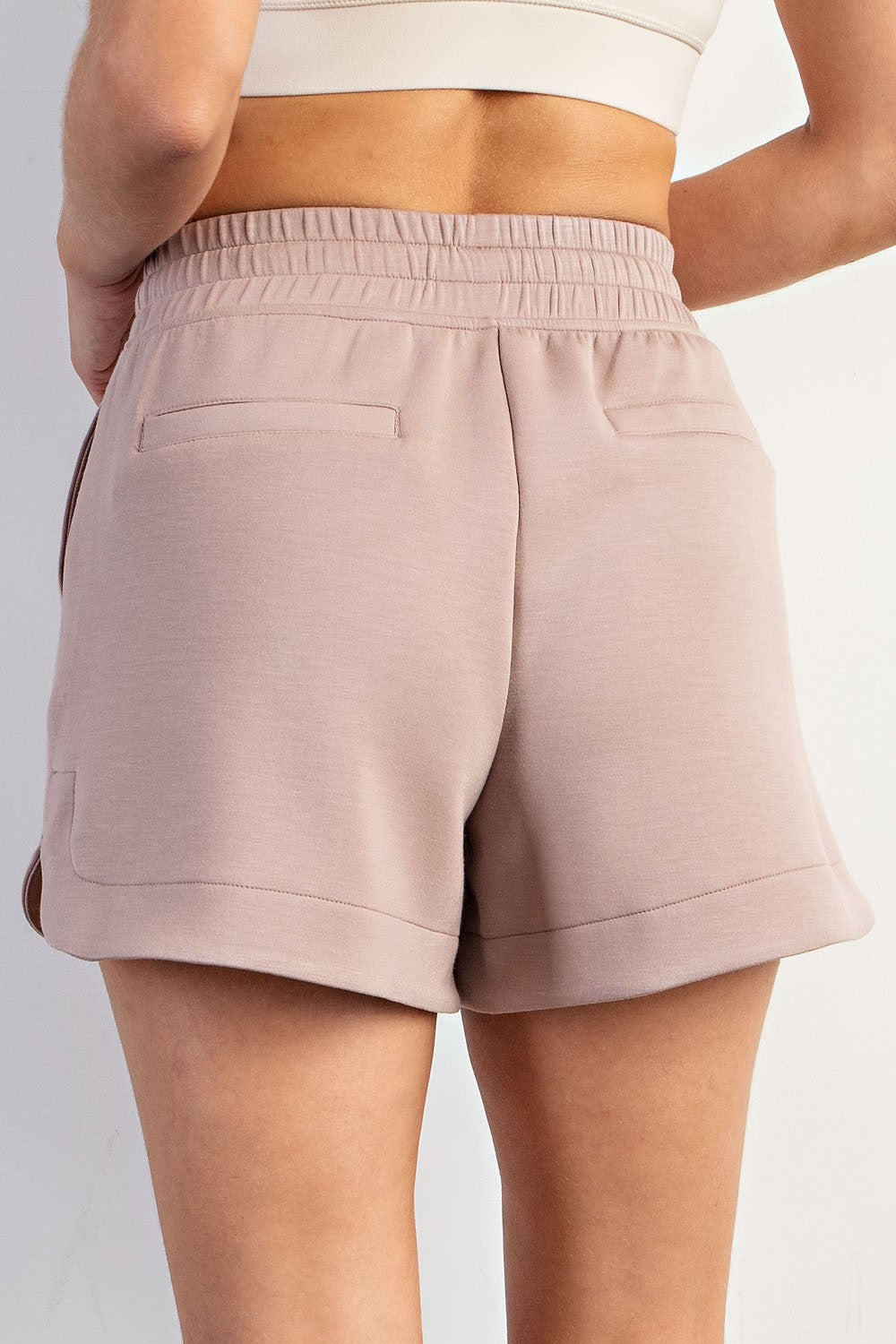 High-waisted, light mauve Modal Scuba Tulip Shorts with elastic waist, two back pockets. Available in sizes XS–XL.