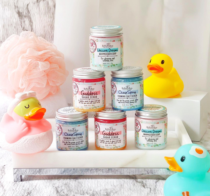 Seven colorful jars of Unicorn Dreams Whipped Bath Soap | Shave Cream mini 3.2oz stacked on a white tray.