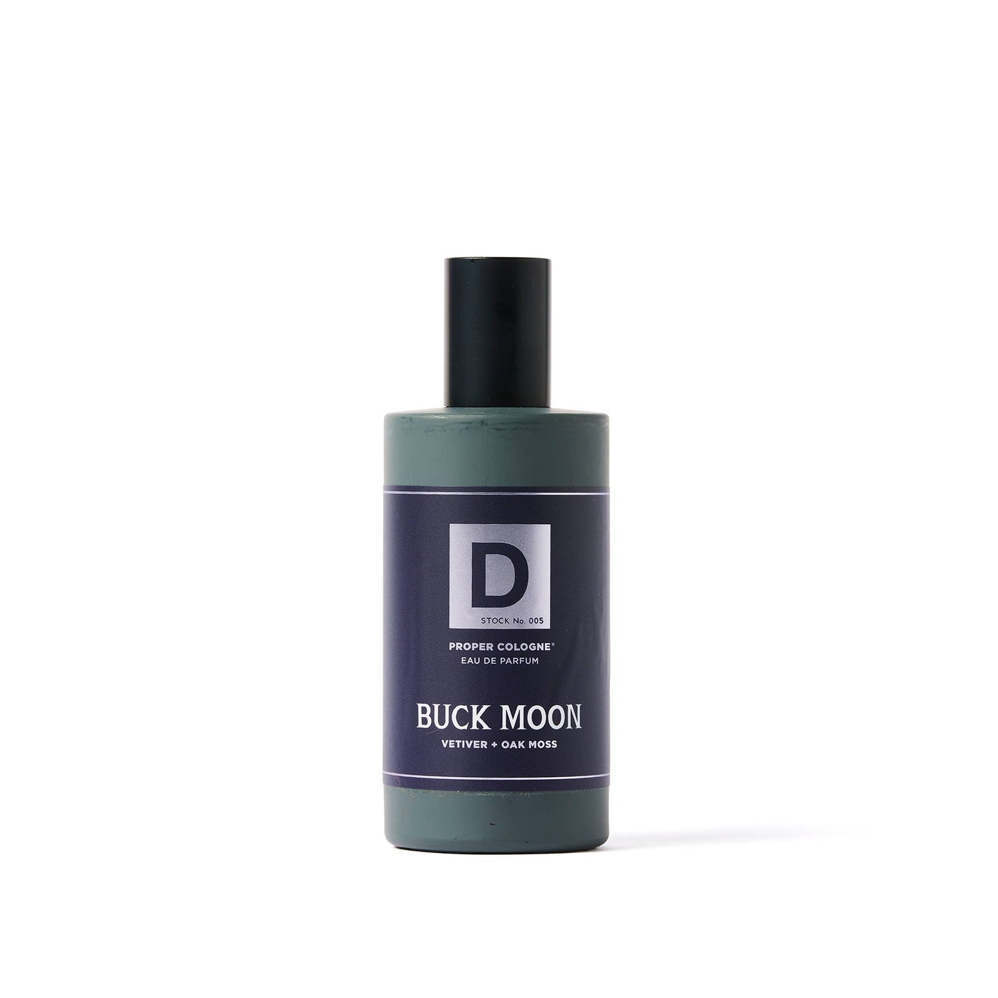Green cylindrical bottle with black cap, dark blue label, white text, "D" logo. Vetiver oakmoss scent. 50ml size available.