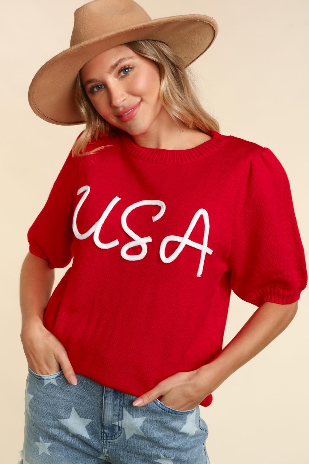 Pop up embroidered puffs sleeved USA top short sleeves with USA on the shirt comes in small medium and large. It is red with white letters.