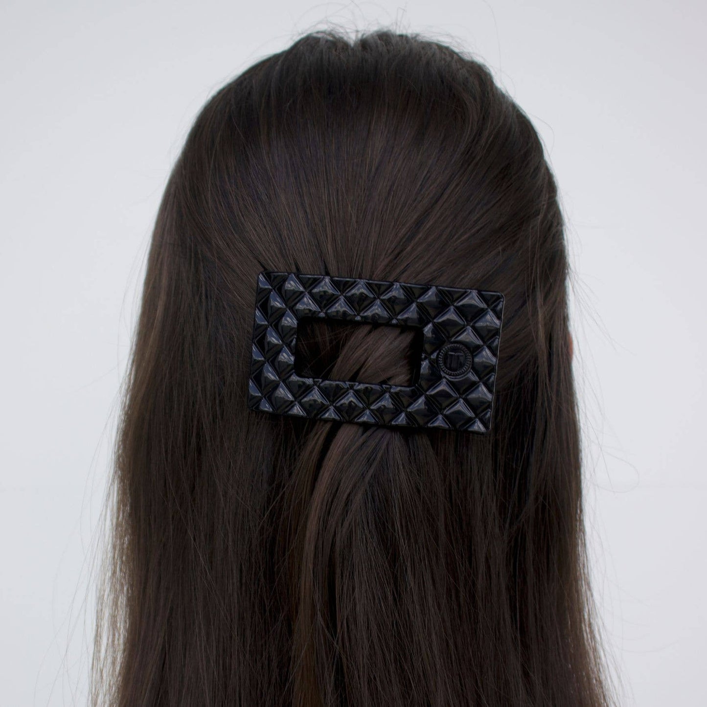 Large black TELETIES Flat Rectangle Hair Clip shown securing hair; available in multiple sizes.