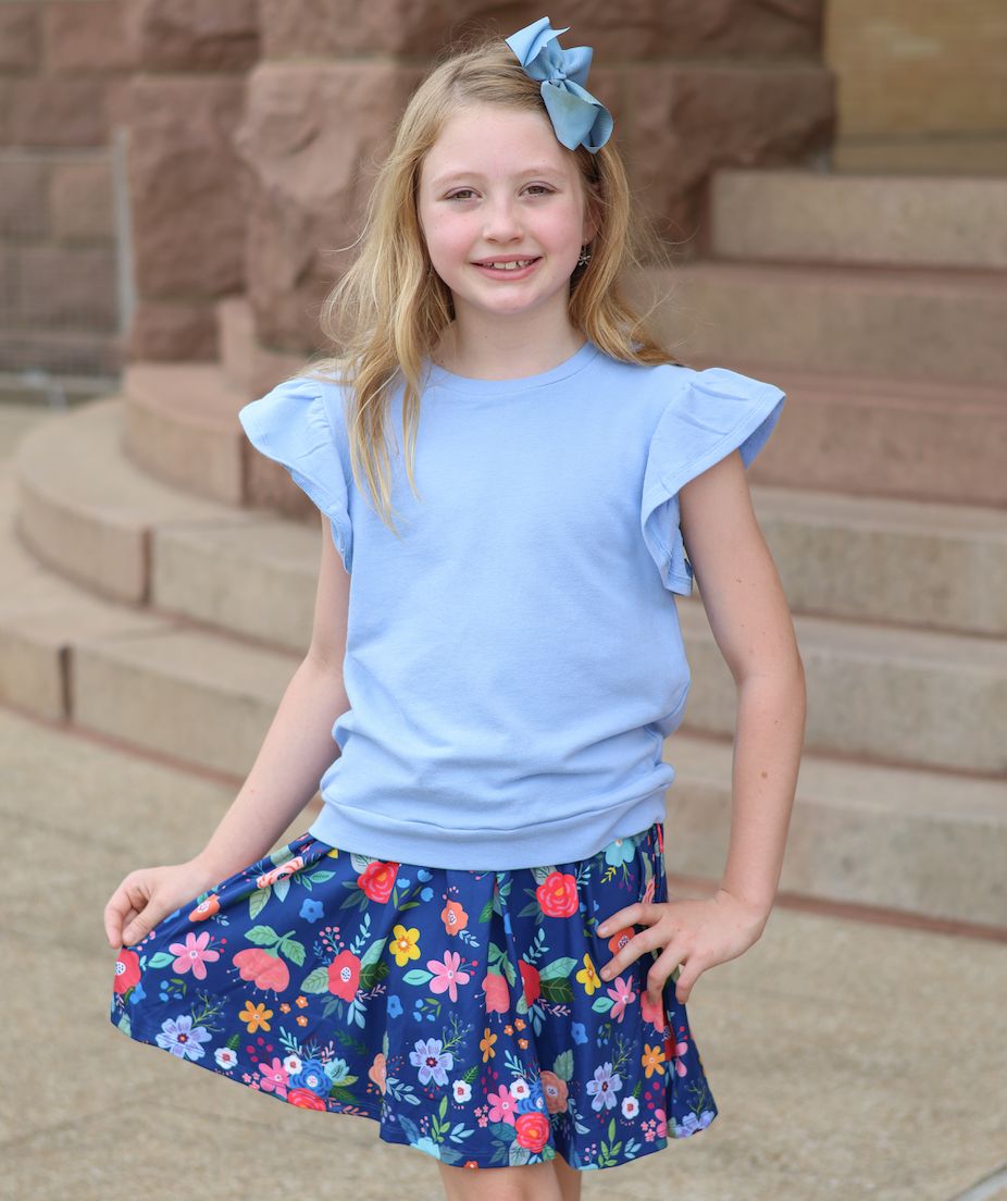 Girls Periwinkle French Terry Top & Four Florals Skort in Periwinkle, available in size 6. Imported; machine washable.