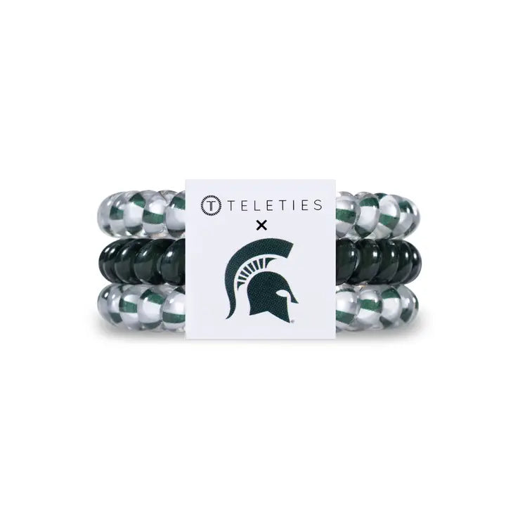 Three TELETIES Hair Ties in green, white, and silver with MSU Spartan logo. Available in small and large sizes.
