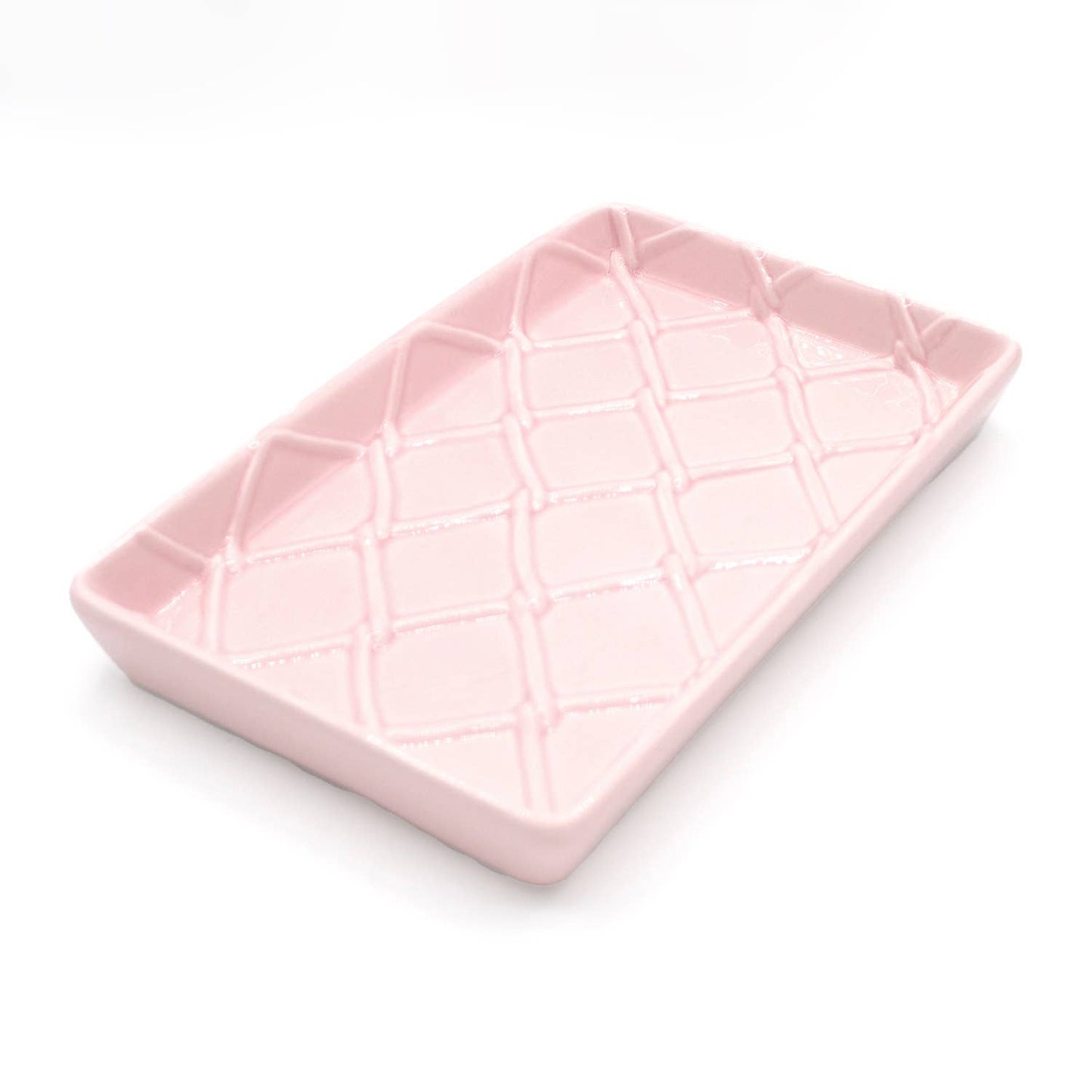 Rectangular light pink ceramic guest towel tray with raised diamond crisscross texture. Available in one size.