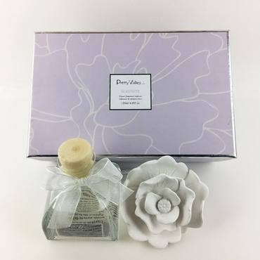 Pastel lavender box labeled "Sunshine Rose Ceramic Flower Diffuser Gift Set - Serenity." Available in 100ml and 200ml sizes.