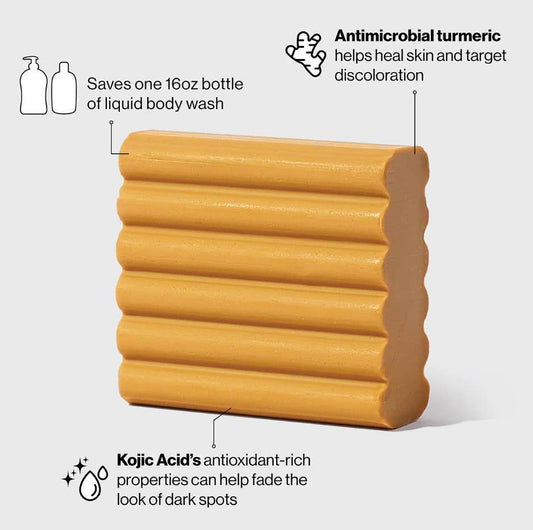 Wavy, rectangular orange Kojic Acid Face and Body Bar; fades dark spots. Available in standard bar size.