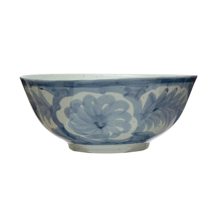 Hand-painted stoneware bowl, 14" wide, features blue floral patterns on white with a wide rim; elegant and traditional.