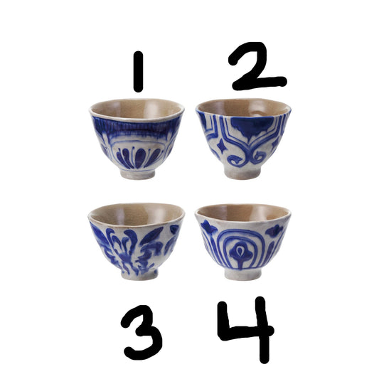 Set of four 10 oz. stoneware bowls/teacups, each hand-painted with unique blue and white designs. Sizes: 10 oz.
