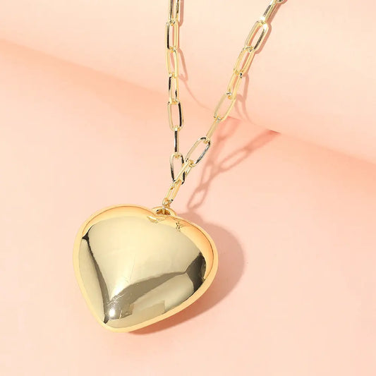 **Metal Puffy Heart Pendant Paperclip Chain Necklace**
- Features: Shiny gold heart-shaped pendant on an elongated link chain.
- Compliance: Lead and nickel compliant for safe wear.
- Sizes Available: 16-inch with a 2-inch extender.