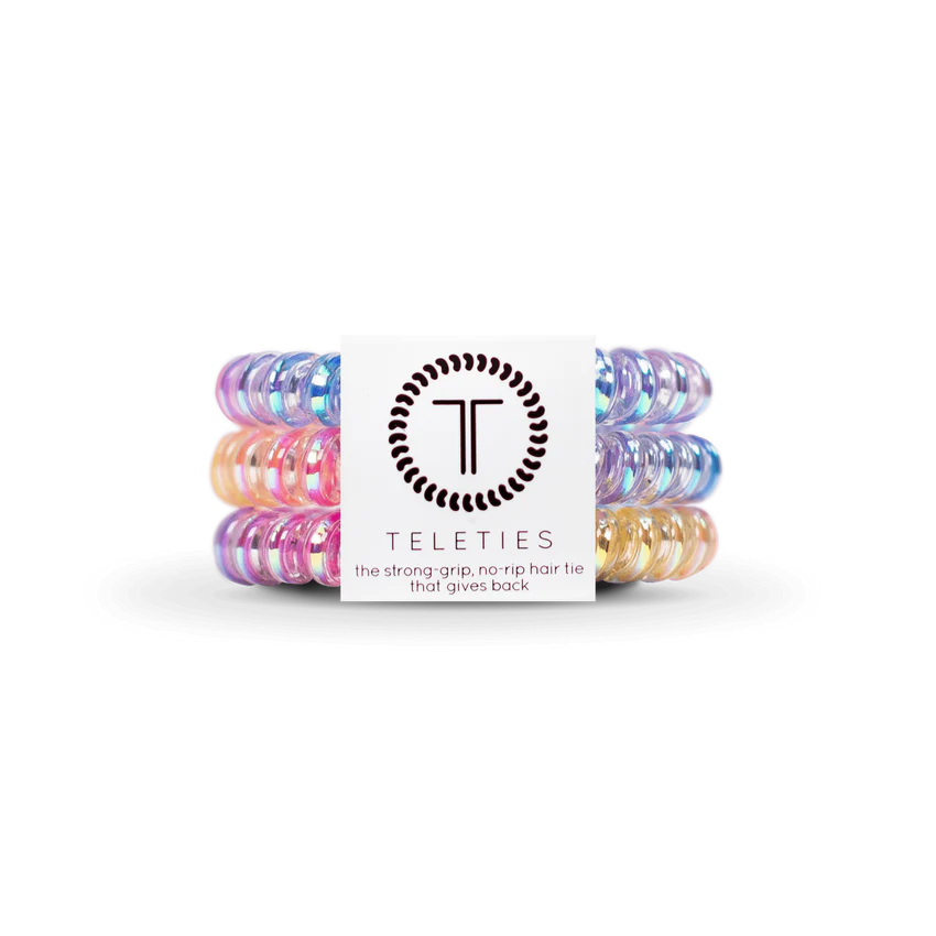 TELETIES Hair Ties: Colorful, glossy coiled hair accessories in pastel pink, blue, purple, and yellow. Offer strong grip and no-rip use. Available sizes: Small and Large.