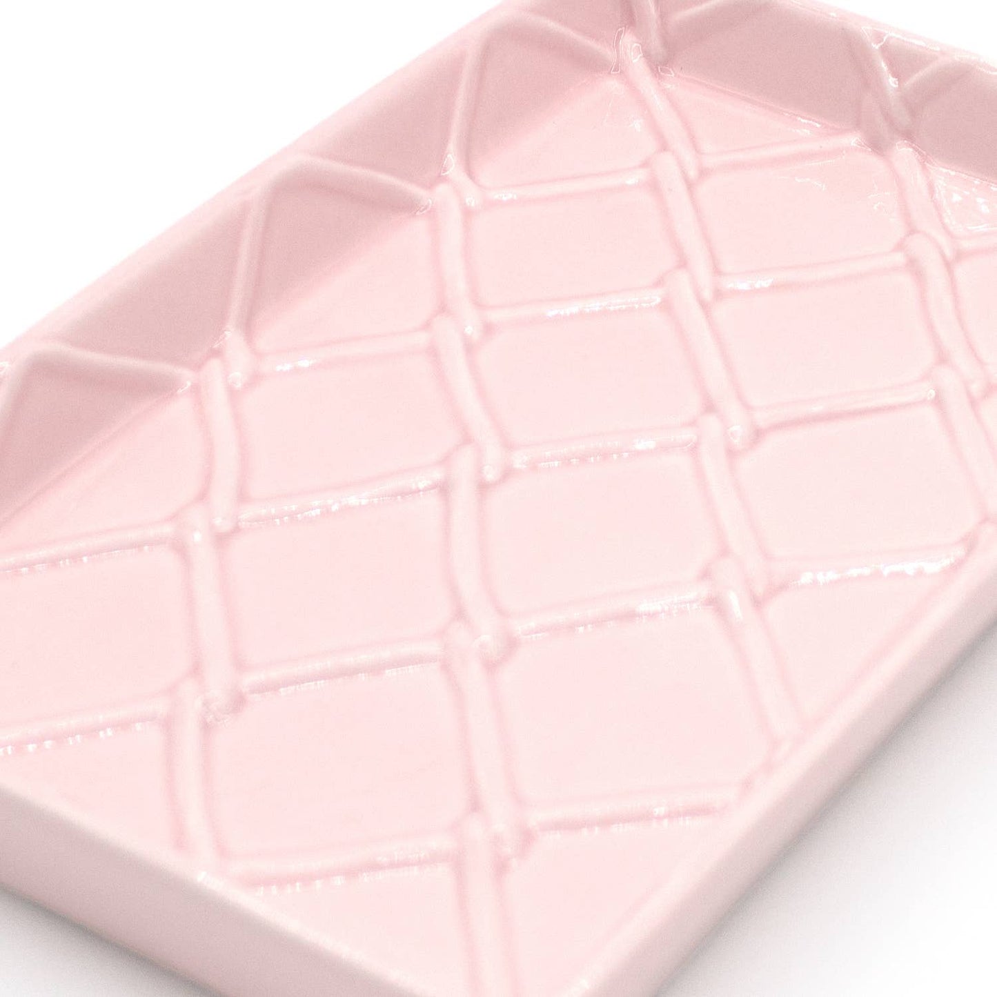 Rectangular, light pink ceramic guest towel tray with raised diamond pattern; available in standard size.