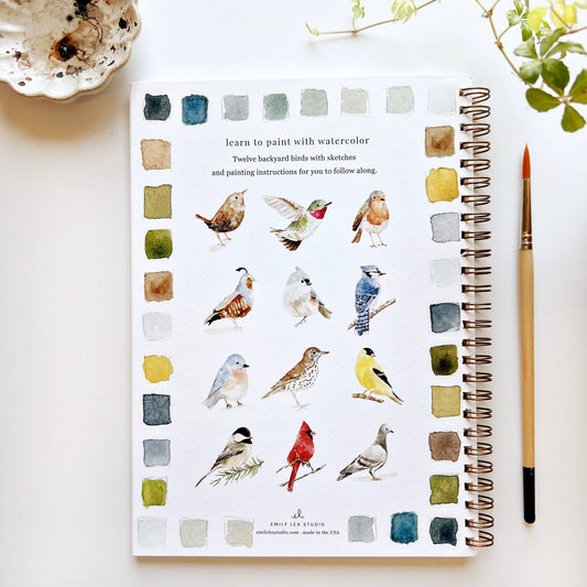Spiral-bound Birds Watercolor Workbook with twelve bird illustrations and paint swatches on the cover. Sizes available: not specified.