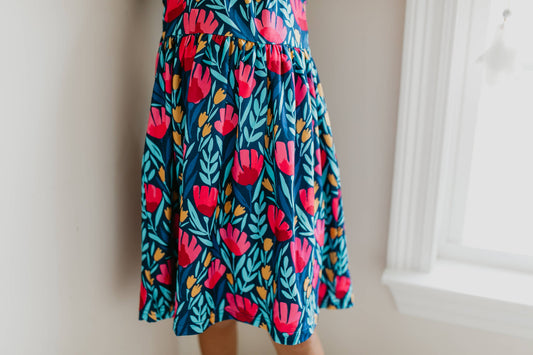 Kids Blue Floral Flutter Sleeve Dress with bright floral pattern. Available in sizes 4T-12.