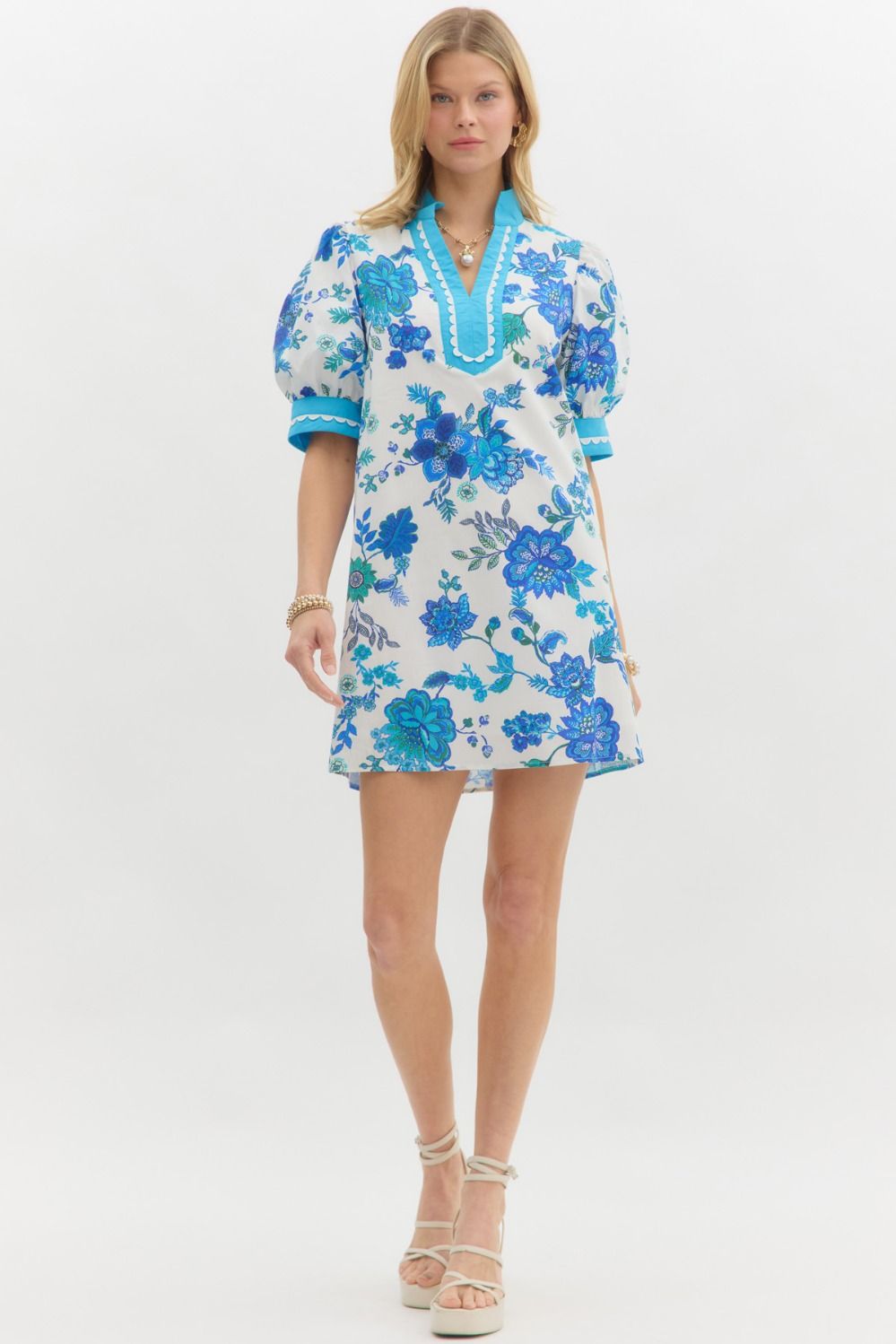 Blue Blossom Caftan Mini Dress: A-line mini dress with puffed sleeves and white floral print. Available in sizes XS–XL.