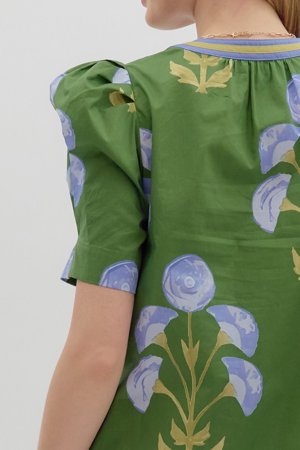 Mabel Blooming Day Top: green floral blouse with puffed short sleeves and blue pattern. Available in sizes XS-XL.
