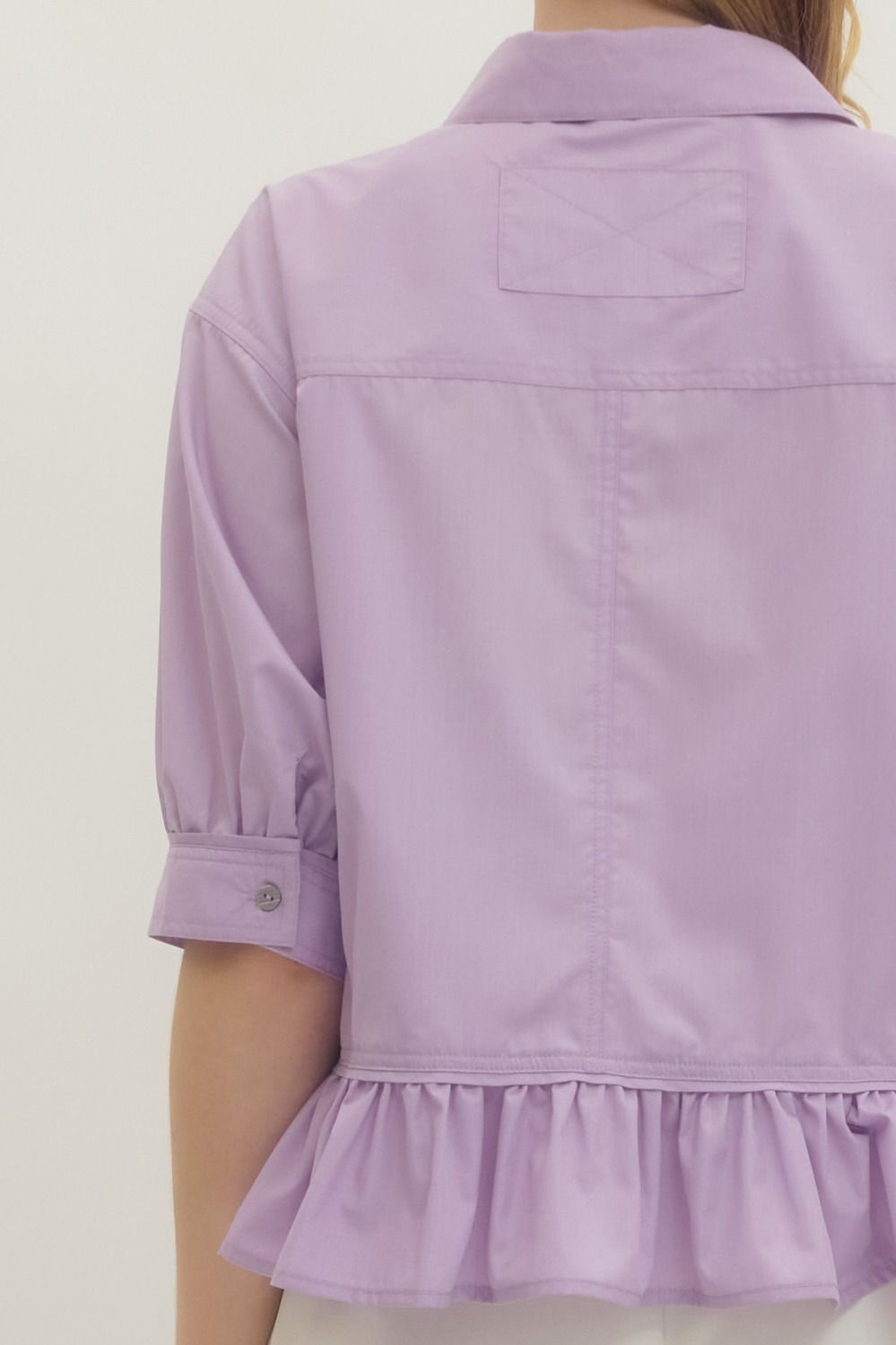 Lavender Ruffle Hem Button-Up Top with half sleeves and ruffle hem; available in sizes XS-XL.