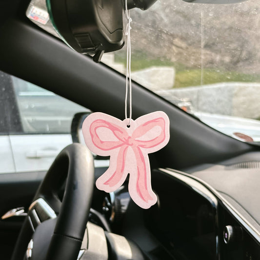Sweet Ride Car Air Freshener–Bow Pink hangs from mirror; available in small and large sizes; delivers long-lasting fragrance.