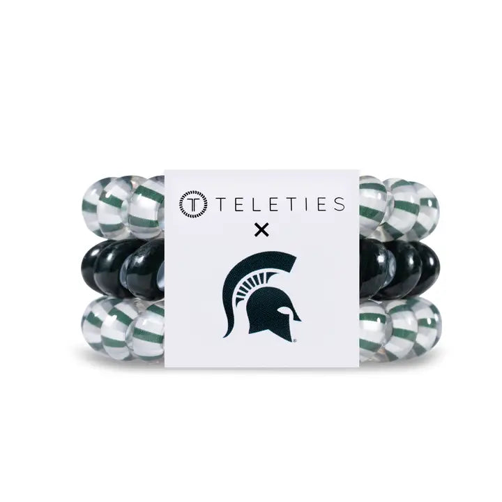 Set of 3 TELETIES Hair Ties in green, black, and clear with branded white band; available in small and large sizes.