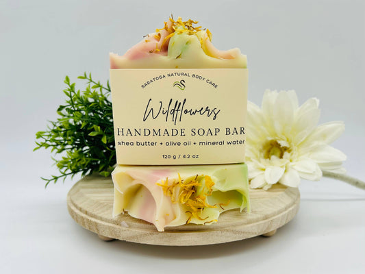 Saratoga Natural Body Care Handmade Soap Bar, Wildflowers fragrance . 4.02 Shea butter, olive oil, mineral water. Cream with pink and green with wildflowers petals.