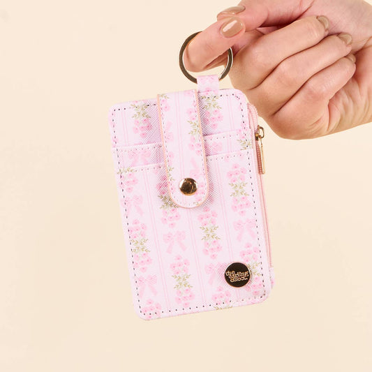 Keychain Wallet–Oh So Fancy Pink: floral pattern, zippered coin holder, buttoned strap, zipper pocket. Sizes: S, M, L.