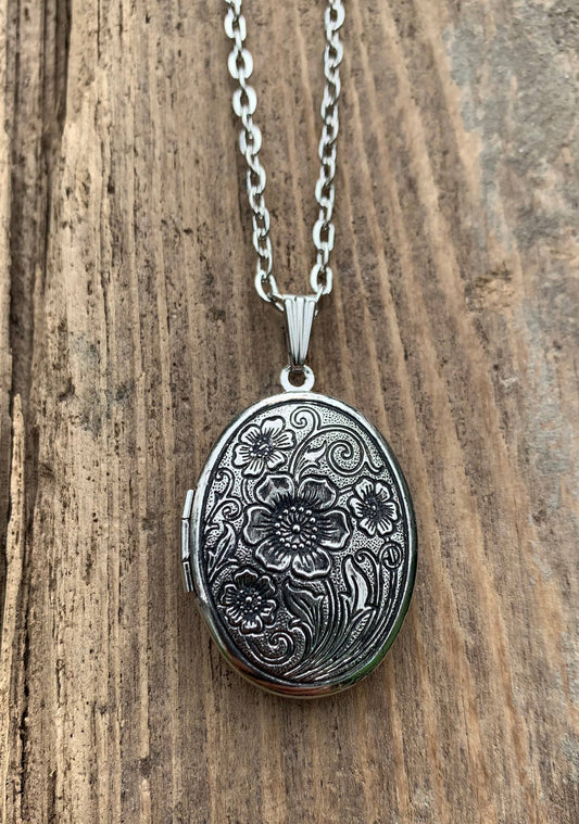 Antiqued silver locket with floral design, holds Moonflower solid perfume. Available in small and medium sizes.