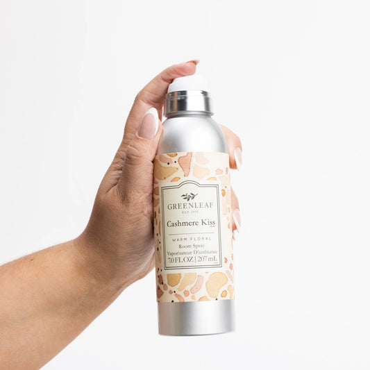 Cashmere Kiss Room Spray with beige and peach floral label, silver bottle. Scent: jasmine, rose, citrus. 6oz size.