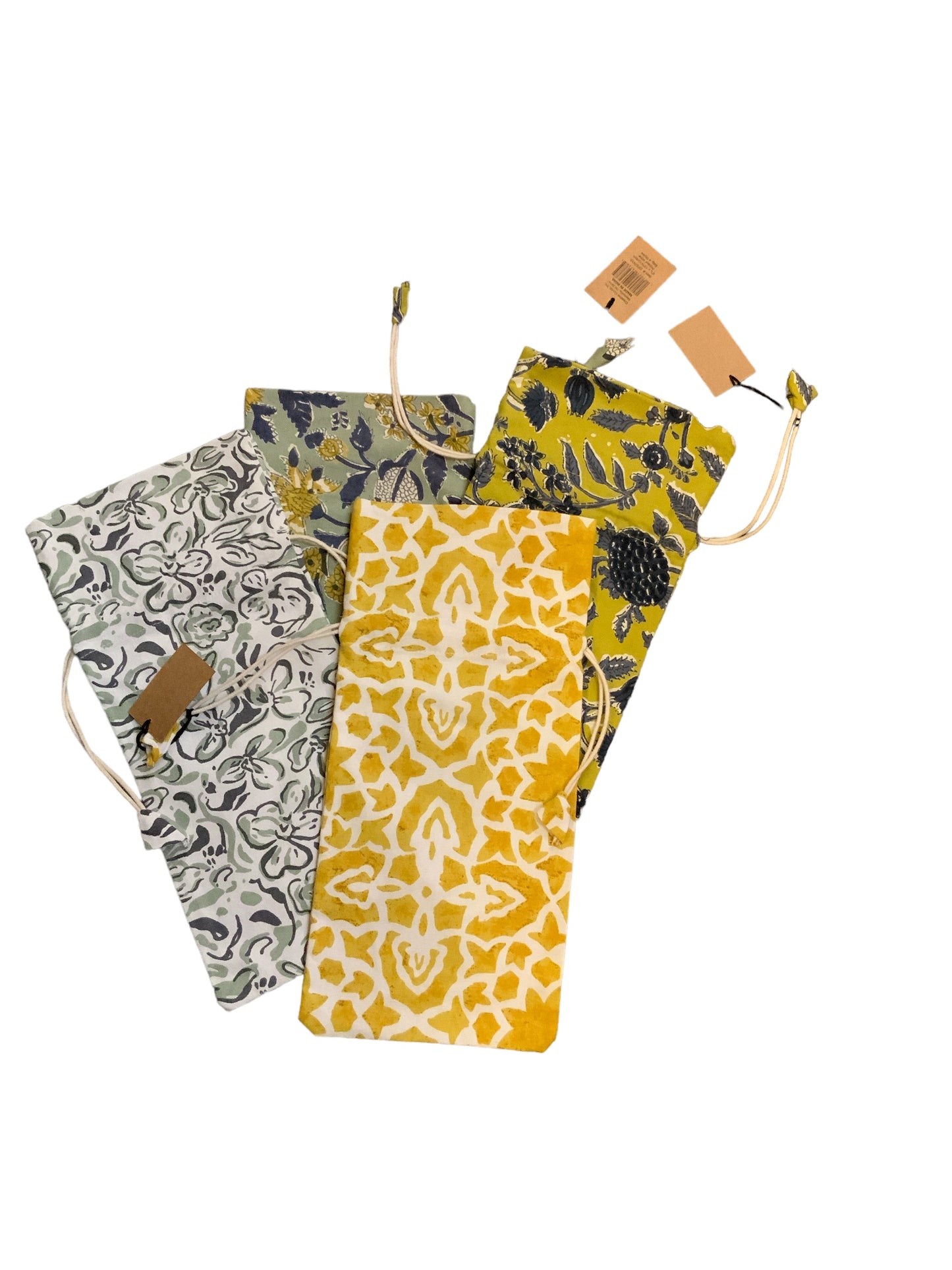 Four cotton wine bags in yellow, blue, green, and black patterns, each with a drawstring and tag. Available in standard size.