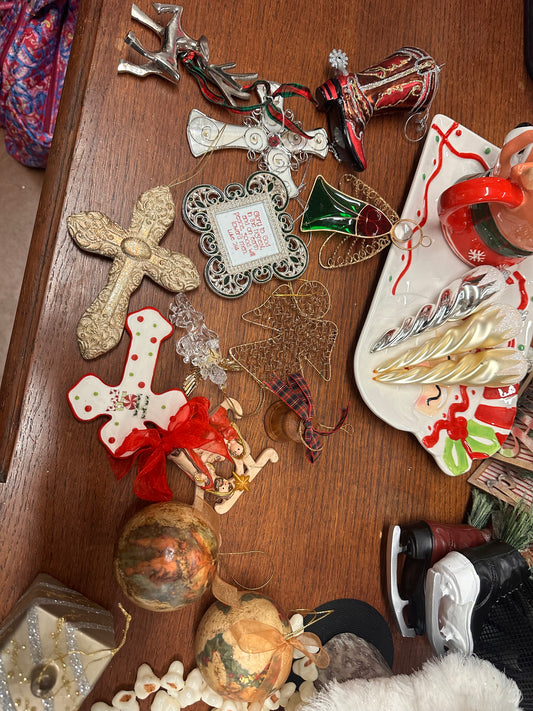 Assorted holiday ornaments: crosses, cowboy boot, reindeer, heart, tree, balls, skates, plaque. Sizes: small to large.