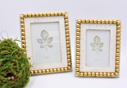 8.5" white wood beaded photo frame with gold accents, fits 4"x6" photos.