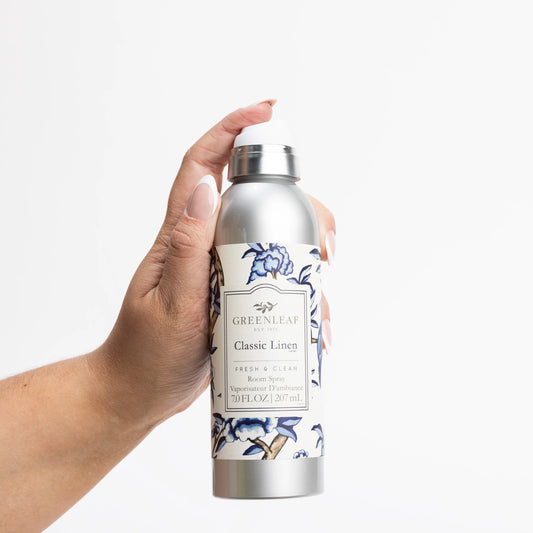 Silver "Classic Linen Room Spray" bottle with blue floral design; clean scent, long-lasting. Available in 4oz and 8oz sizes.