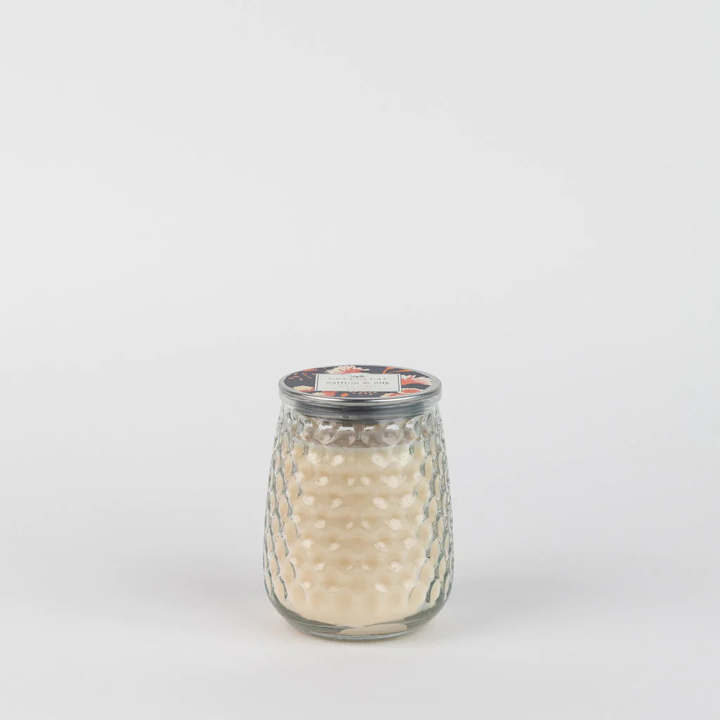 Saffron & Silk Signature Candle (GLG915573) by Greenleaf in a clear, textured glass jar with silver lid. Size options available.