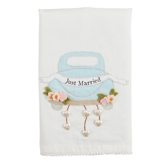 The Wedding Beaded Tea Towel is a white cotton hand towel featuring a premium appliqué of a blue car with "Just Married," adorned with flowers and heart charms. Available in standard size.