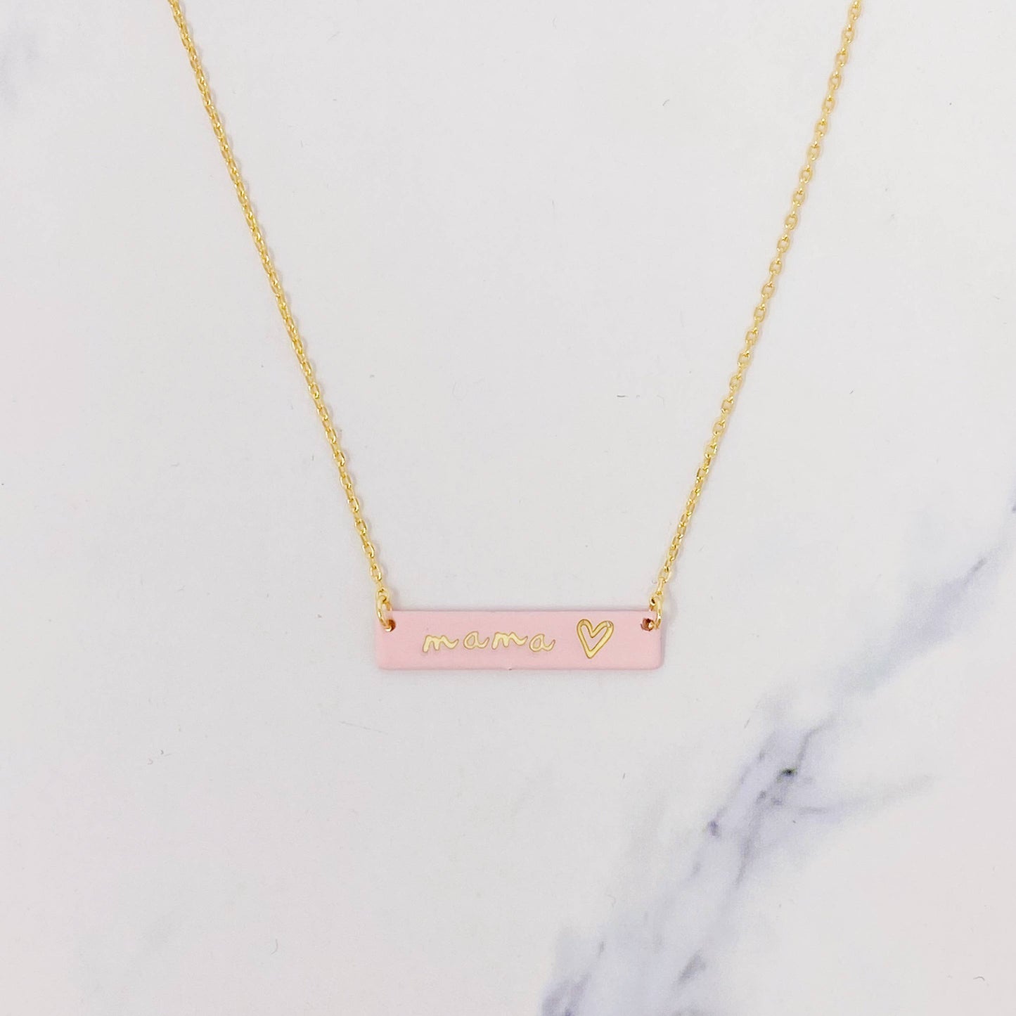 Gold "mama" bar necklace with small gold heart and pink rectangular pendant. Available in 16", 18", and 20" lengths.